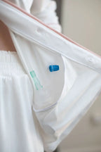 Just Because Love Does Healing Collection pajama top in white and pink, showcasing an inner access pocket for medical use or storage.